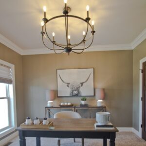 carpeted home office with freestanding desk in the middle of room
