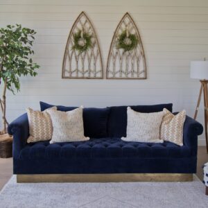 modern blue sofa on area rug, on top of a white oak hardwood floor
