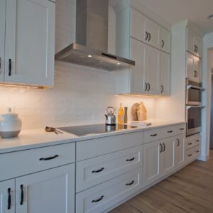 modern farmhouse kitchen with white shaker cabinets and ceramic tile backsplash
