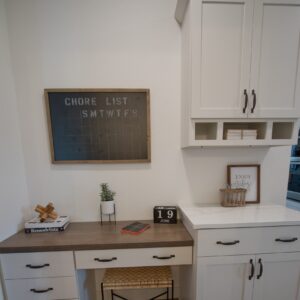 A white desk with wood countertop built into hallway of home