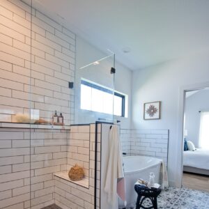 Bathroom with white walls, and black and white vintage patterned floor.