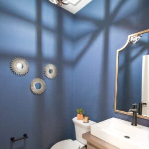 modern Indigo blue powder room with black and white vintage pattern porcelain tile on floor
