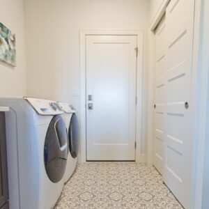 laundry room with a decorative sheet vinyl on the floor