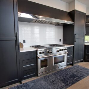 modern lakehouse kitchen with white tile backsplash and luxury vinyl floors