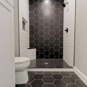 black and white bathroom using matte black hexagon tile