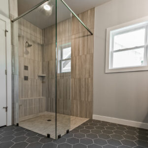 warm transitional style bath with hexagon tile floors