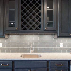 transitional organic home bar with blue glass backsplash