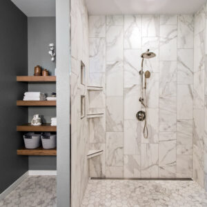 gray walls, floating wood shelves with zero-entry tiled shower