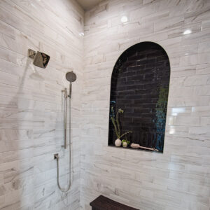 transitional french tudor shower with black tile in niche and marble wall tile from coyle carpet one