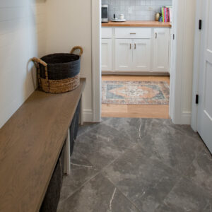 Transitonal Boho garage entryway design made with a stone-look ceramic tile
