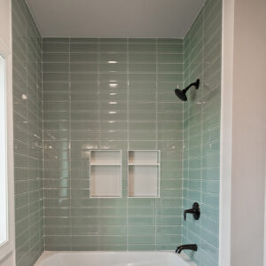 chic geometric modern guest bathrom with mint colored tile surround