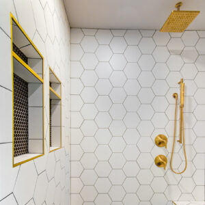 chic geometric modern black and white primary shower with gold accents