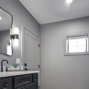 Classic Elegance Design, Bathroom with dark wood vanity, white quartz countertop, and wood-look vinyl flooring that adds warmth, elegance, and durability to the space.