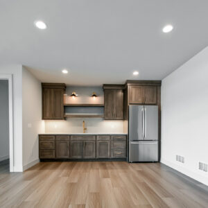 Classic Elegance Design, Home coffee bar featuring medium stained wood cabinets, white quartz countertop, and white rippled wall tile in a modern design.