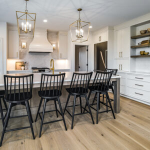 Classic Elegance Design, Modern kitchen showcasing engineered hardwood flooring in Whitlock Beige from MSI’s McCarran collection, paired with a natural stained island and white quartz countertop