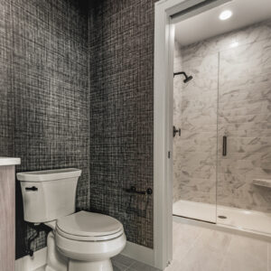 First floor bathroom featuring 12x24 porcelain tile flooring and 4x12 shower wall tile, both in Brilliant White from Daltile’s Perpetuo Collection, for a cohesive and elegant design