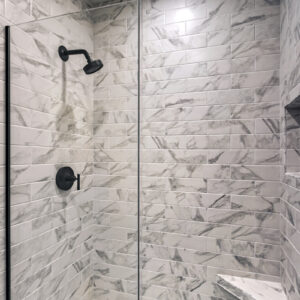 First floor bathroom shower featuring 4x12 wall tile in Brilliant White from Daltile’s Perpetuo Collection creating a bright and modern look