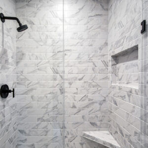 Classic Elegance Design, View of the first floor bathroom shower showcasing 4x12 Brilliant White wall tiles from Daltile’s Perpetuo Collection for a clean, contemporary aesthetic