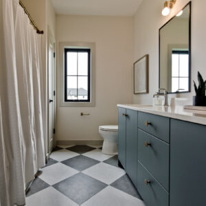 modern transitional elegance Contemporary bathroom featuring black and white checkered tile, a blue green bathroom vanity with flat doors, and white quartz countertops