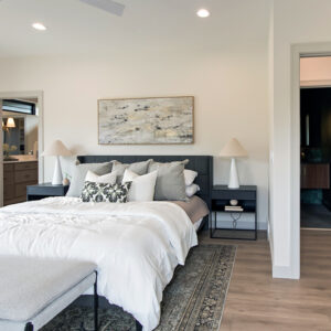 modern transitional elegance, Primary bedroom featuring Casabella Carolina Coastal luxury vinyl plank flooring in South Khaki-Lackey, installed by Coyle Carpet One in Madison, WI. Durable and stylish wood-look floors complement the serene design.