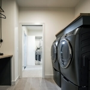 modern transitional elegance Laundry room showcasing Daltile Wanderwise 12x24 porcelain tile in Swan and Drift, installed by Coyle Carpet One in Madison, WI, combining style and practicality.