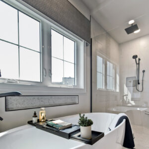 Enjoy a glimpse into this modern bathroom featuring a beautifully designed shower with premium tile finishes, offering a sleek and stylish retreat for relaxation.
