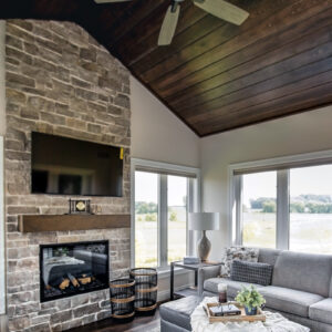 This inviting 4-season room at features the warm, natural tones of Paramount Streamside Hickory flooring, offering both durability and elegance for year-round enjoyment.