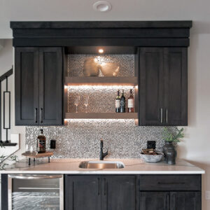 The home bar is beautifully accented with Daltile Gaineswood 6x24 Walnut tile, creating a warm, inviting atmosphere with its rich, natural wood look.